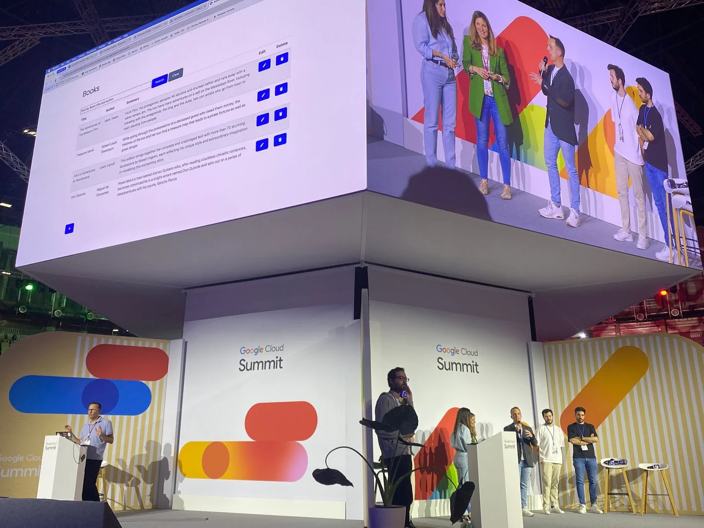 Conference stages and large screens showing speakers and a book-catalogue application demonstration.