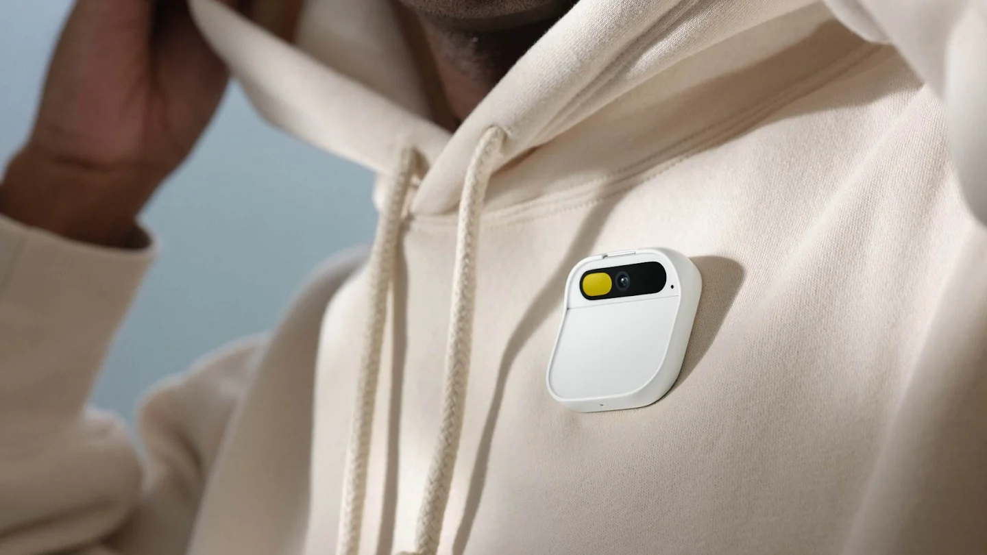 A white Humane Pin attached to a light-coloured sweatshirt.